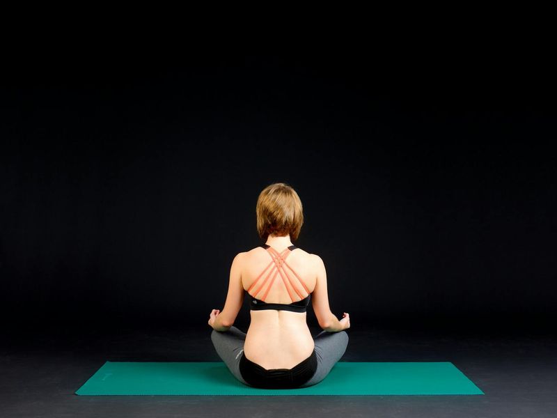 Person practicing mindful movements in a calm, minimalist room.